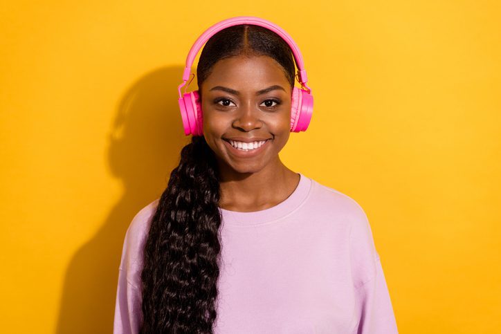 Portrait of positive friendly person enjoy listen favorite song rest relax isolated on yellow color background